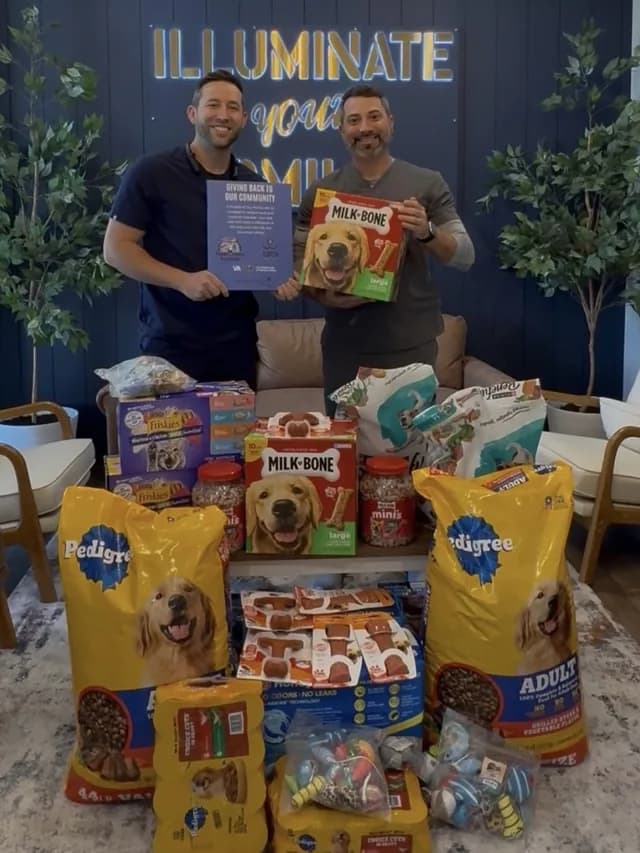Dr. Wolf and Dr. Honig with pet food and supplies donated to the Humane Society of Tampa Bay