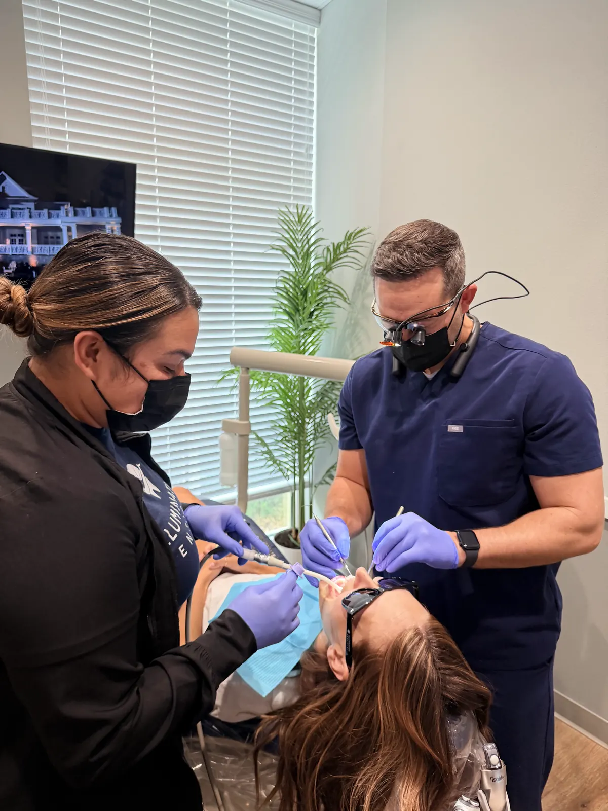 Dr. Brandon Wolf and Staff 4 performing a dental cleaning and checkup