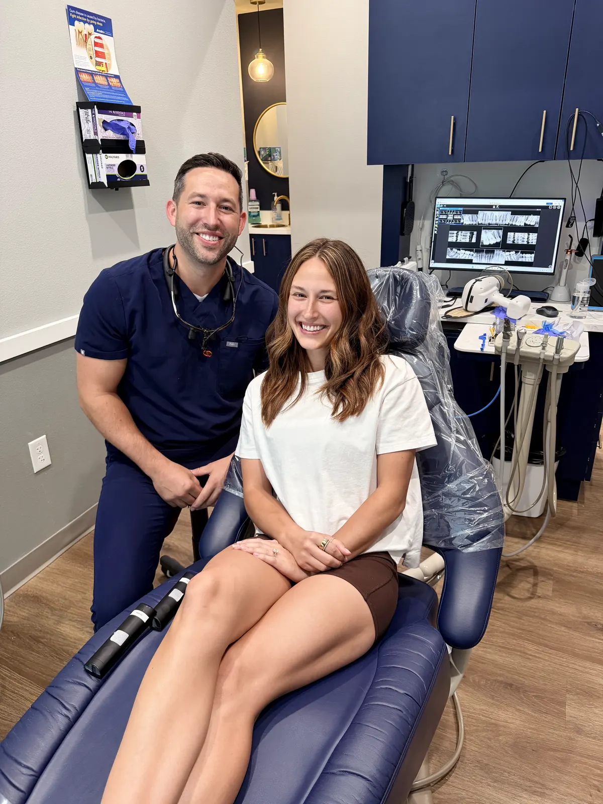 Dr. Brandon Wolf with a smiling patient seated in the dental chair